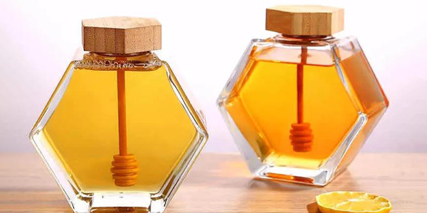 hexagonal glass honey jar with wooden lid
